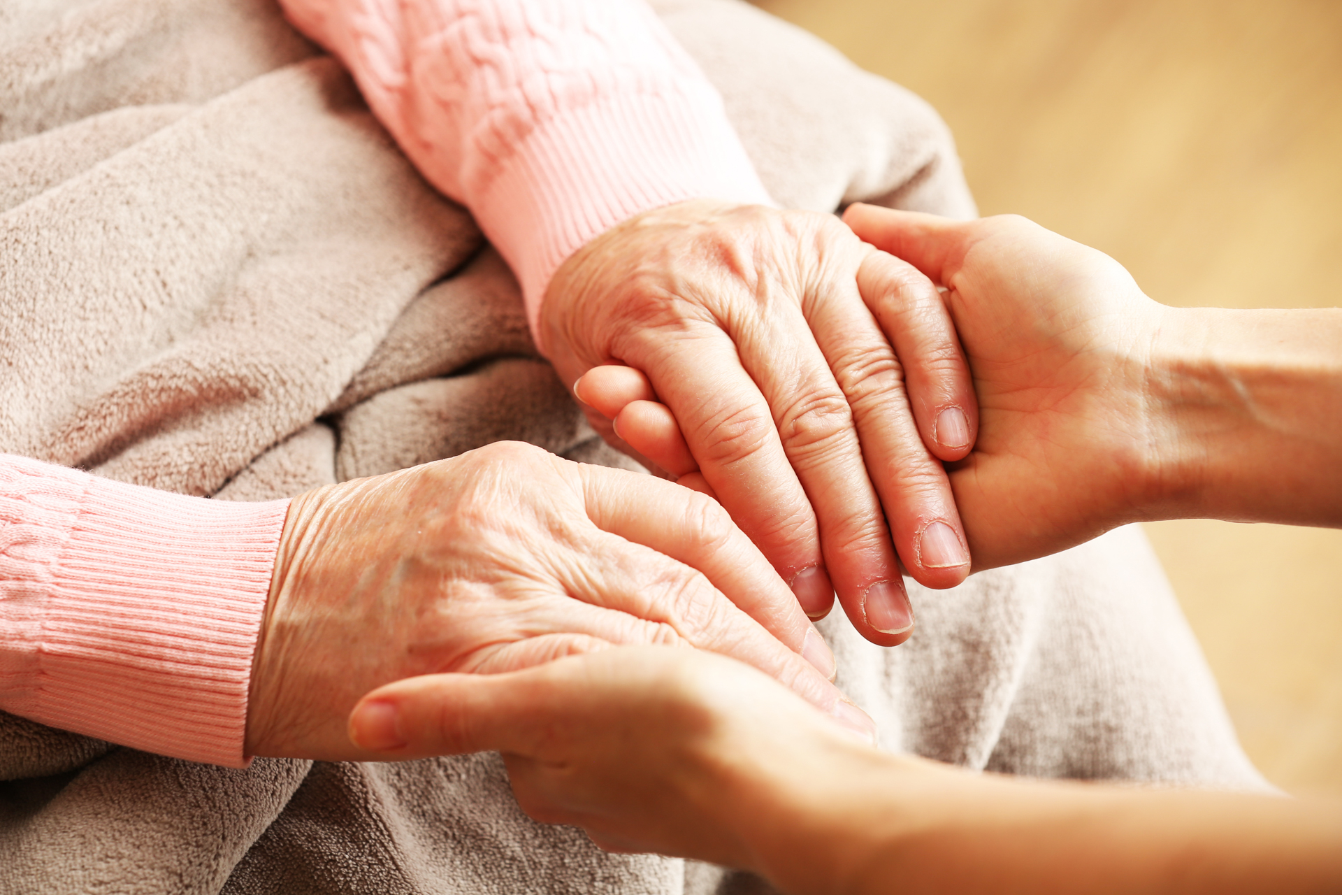 Caregiver holding senior's hands - compassionate dementia and personal care in Northern Virginia