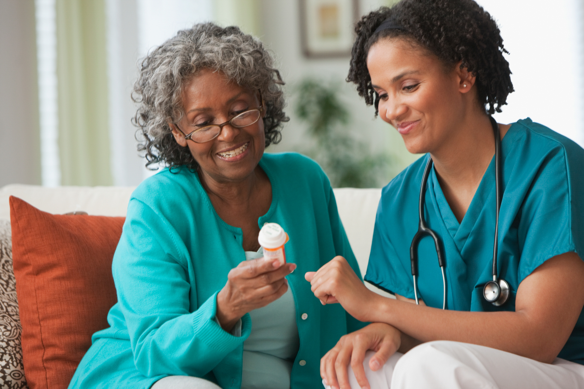 Home caregiver providing medication reminder to senior - Devoted Care LLC Virginia