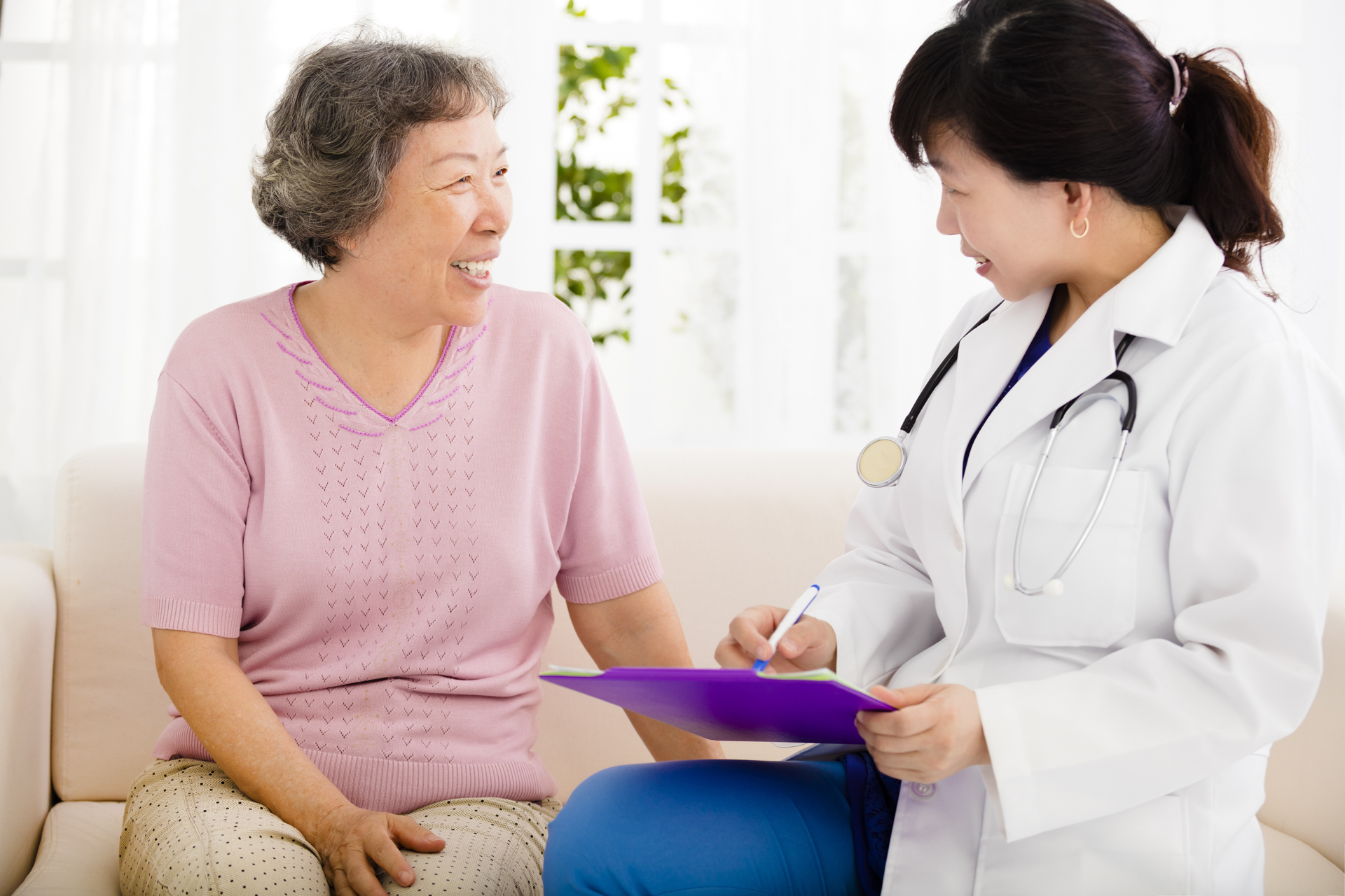 Devoted Care LLC caregiver reviewing care plan with senior client in Virginia